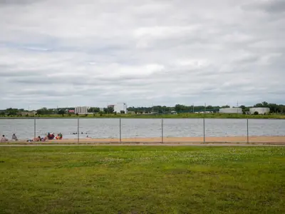 wide view of cascade lake beach with a few people relaxing in the sand
