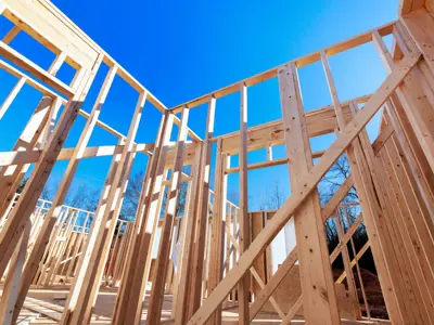 framed walls on a home construction site on a blue skied day