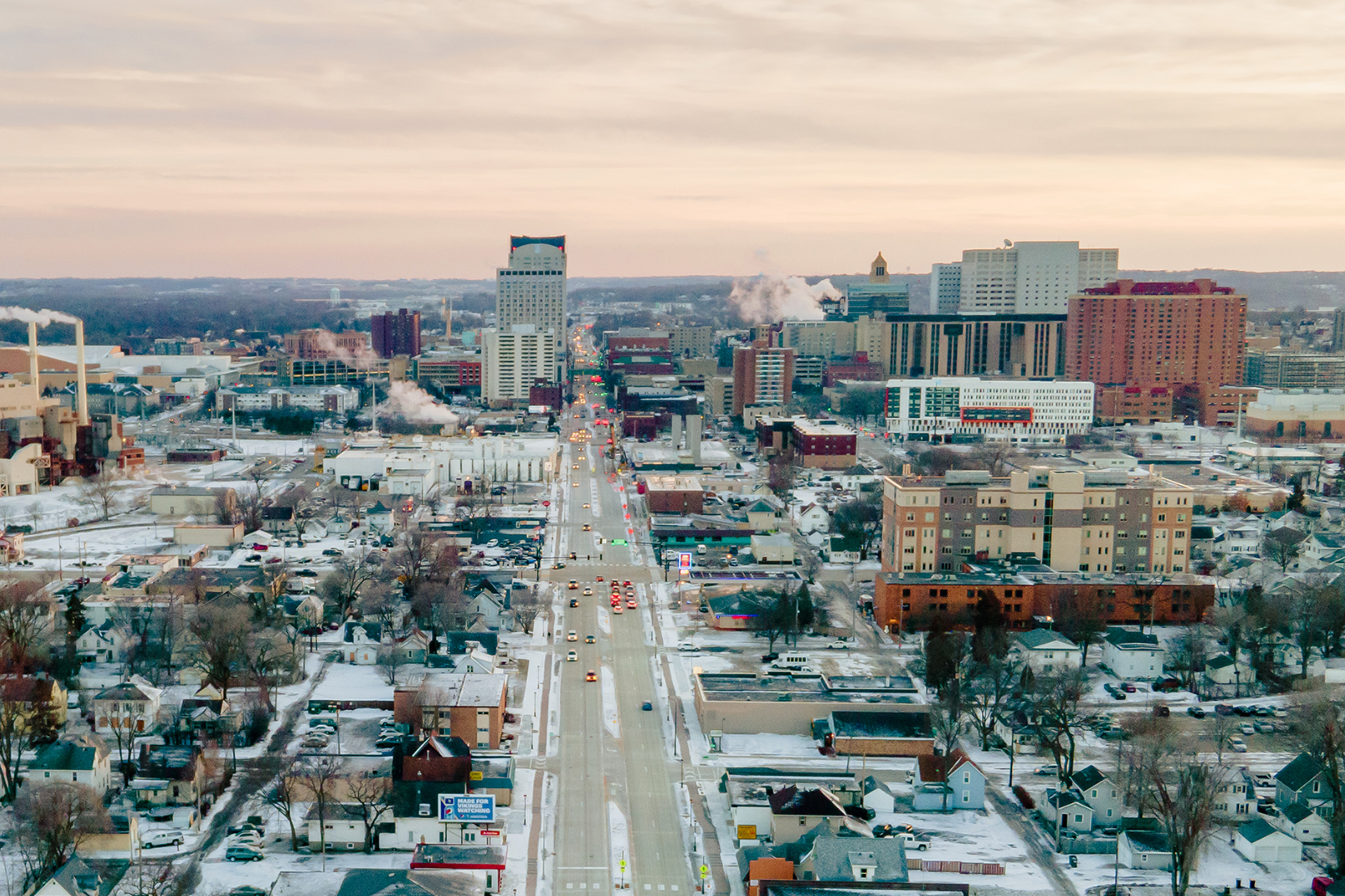 drone view of downtown rochester during the winter season with snow on the ground